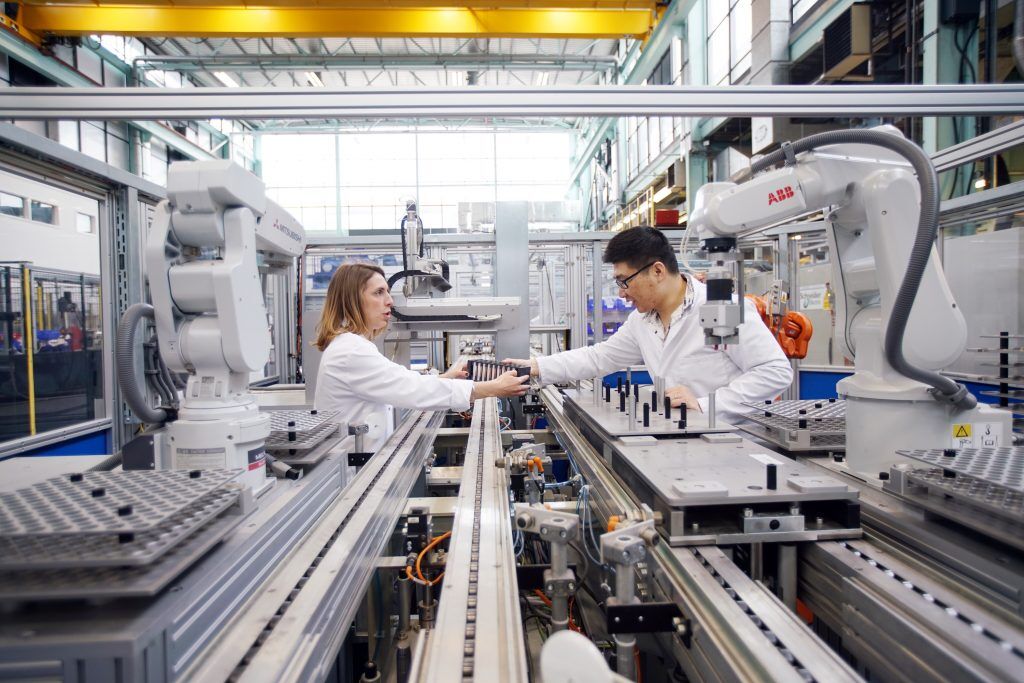 Two manufacturing engineers checking equipment
