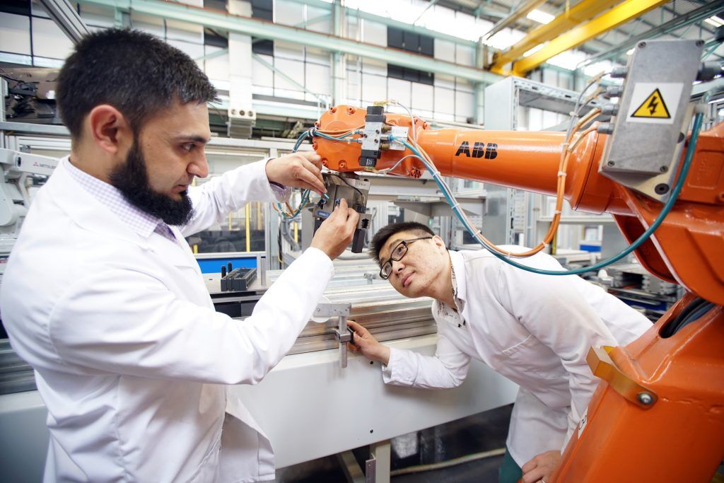 Engineers check digital manufacturing equipment