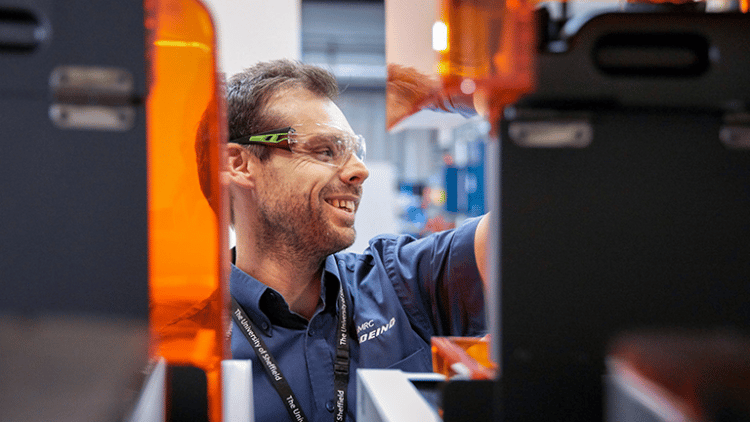 Engineer behind manufacturing equipment