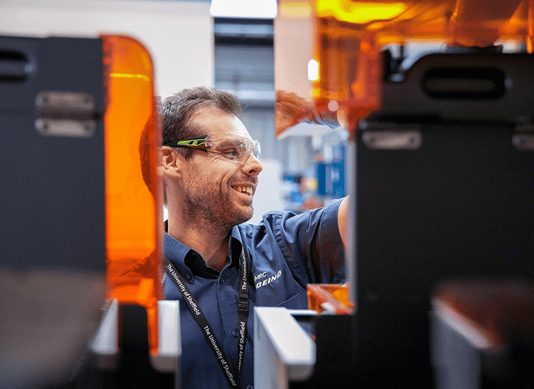 Engineer behind manufacturing equipment