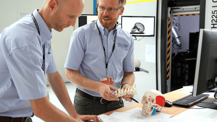 Two HVMC employees solving a problem together at a desk