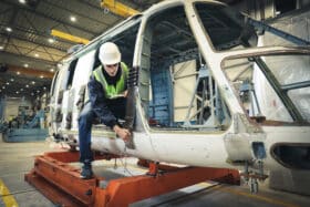 Person working on helicopter chassis