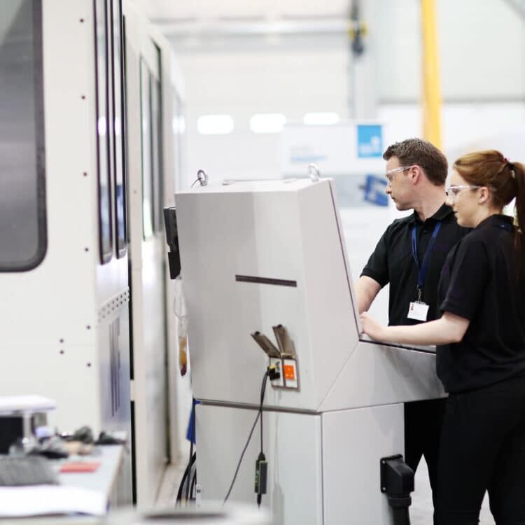Apprentices use manufacturing equipment
