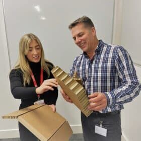 Two people test a manufacturing product