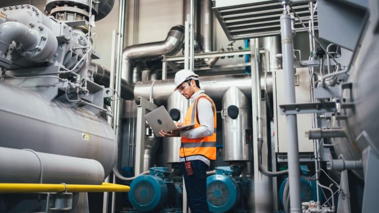 Professional worker of modern factory using laptop