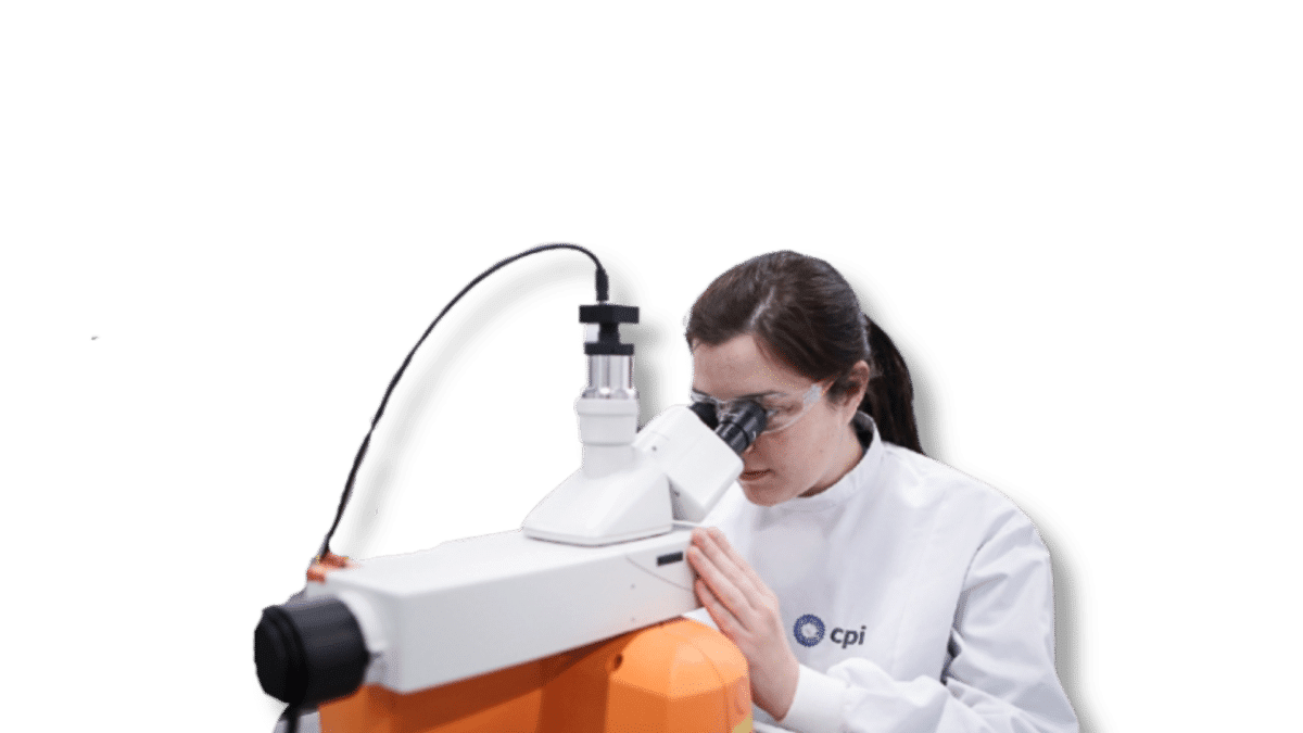 Female engineer from CPI conducting experiments with microscope
