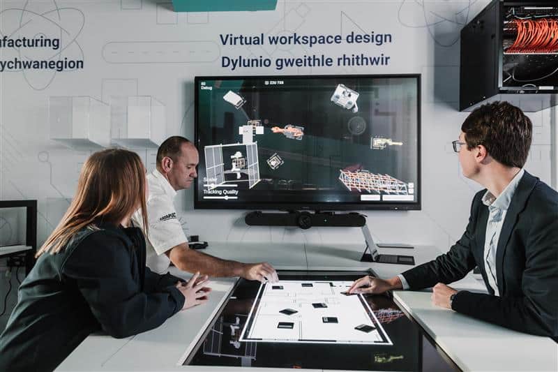 3 people sitting in-front of a virtual workspace