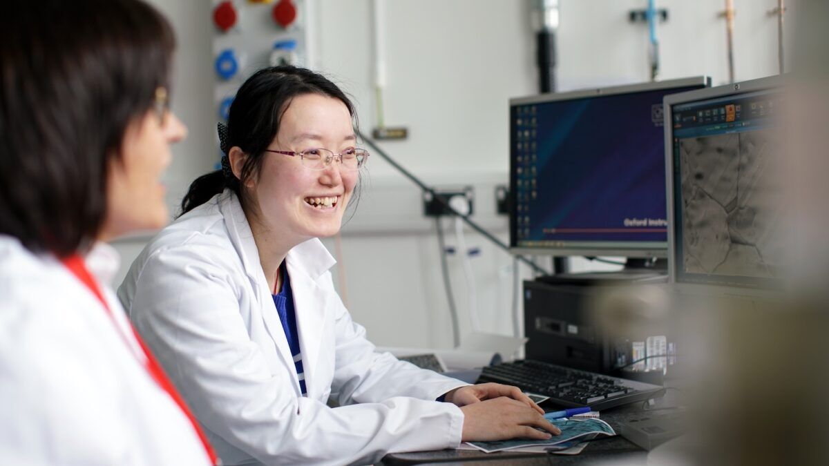 Two Scientists smiling whilst working